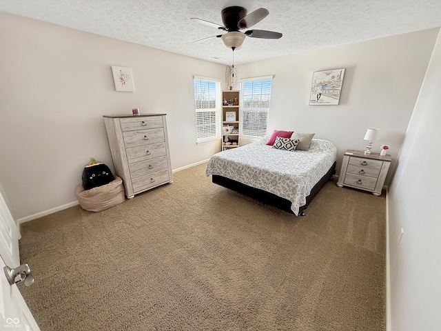 bedroom with light carpet, a textured ceiling, and baseboards