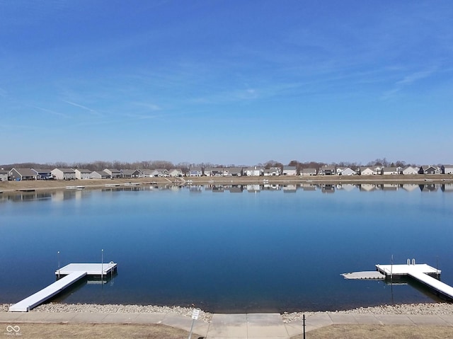 dock area featuring a residential view and a water view