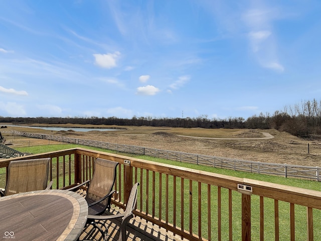 wooden deck with a lawn, a fenced backyard, and a rural view