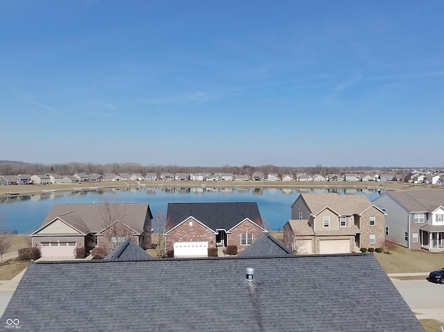 bird's eye view with a residential view and a water view