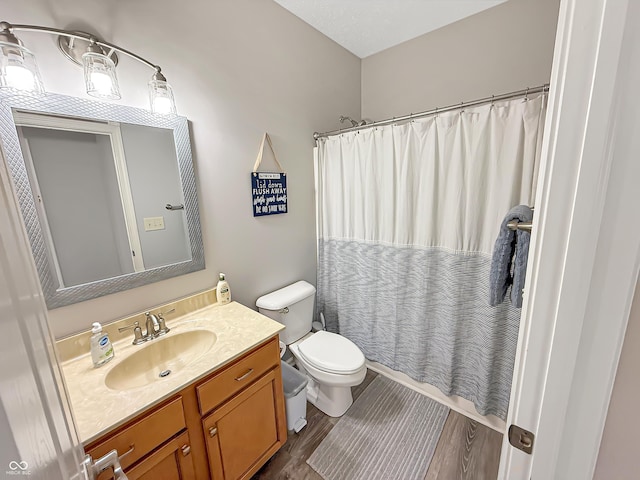 full bathroom with a shower with curtain, toilet, wood finished floors, and vanity