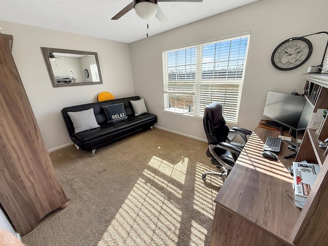 home office with a ceiling fan, carpet, baseboards, and a textured ceiling