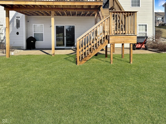 exterior space featuring a patio area, stairway, a lawn, and a deck