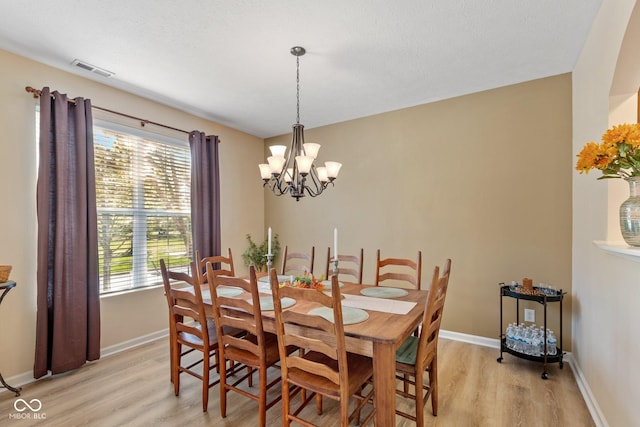 dining space featuring light wood finished floors, baseboards, and a wealth of natural light