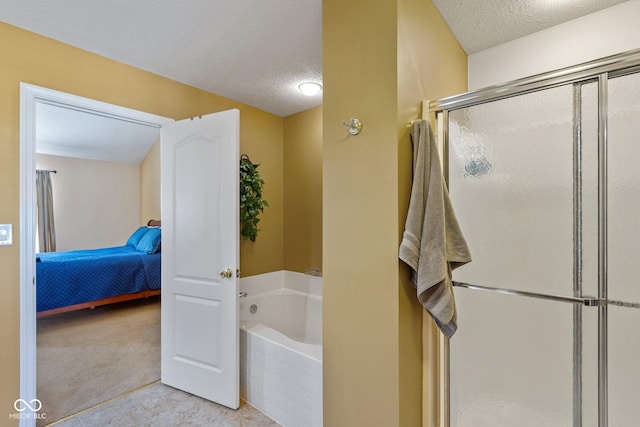 ensuite bathroom featuring tile patterned floors, a garden tub, a stall shower, ensuite bathroom, and a textured ceiling