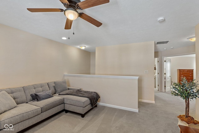 living area featuring visible vents, light carpet, and baseboards