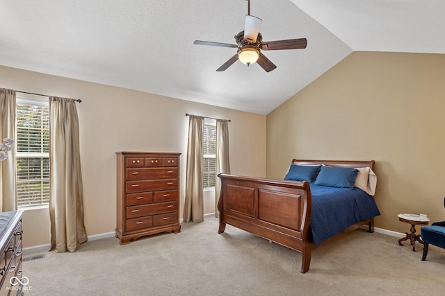 bedroom featuring light carpet, a ceiling fan, baseboards, and vaulted ceiling