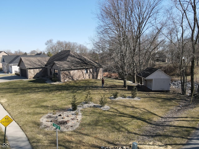 view of front of home featuring a garage, concrete driveway, and a front lawn