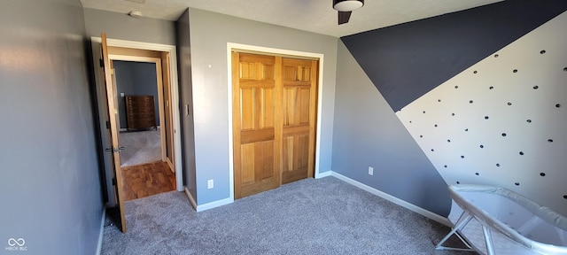 unfurnished bedroom featuring baseboards, a closet, and carpet floors