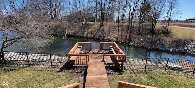 dock area featuring a yard, fence, and a water view