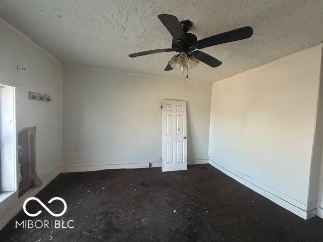 unfurnished room with baseboards, a textured ceiling, and a ceiling fan