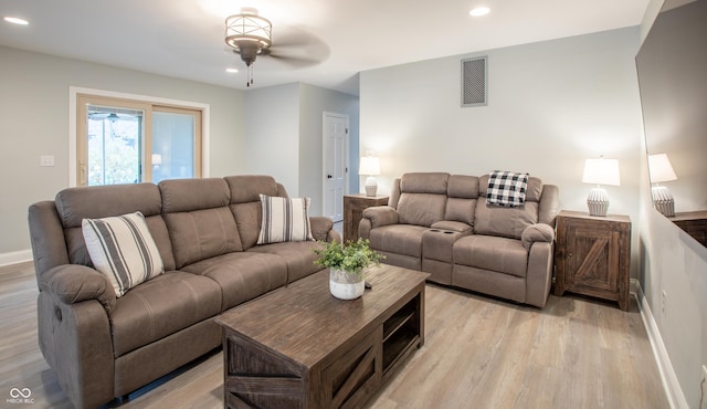 living area featuring light wood finished floors, visible vents, and recessed lighting