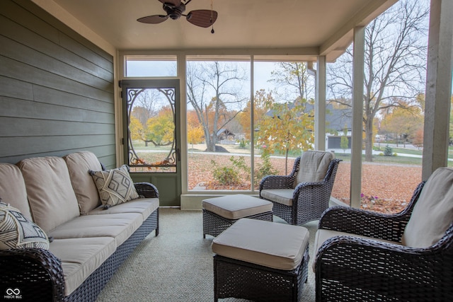 sunroom / solarium featuring a ceiling fan