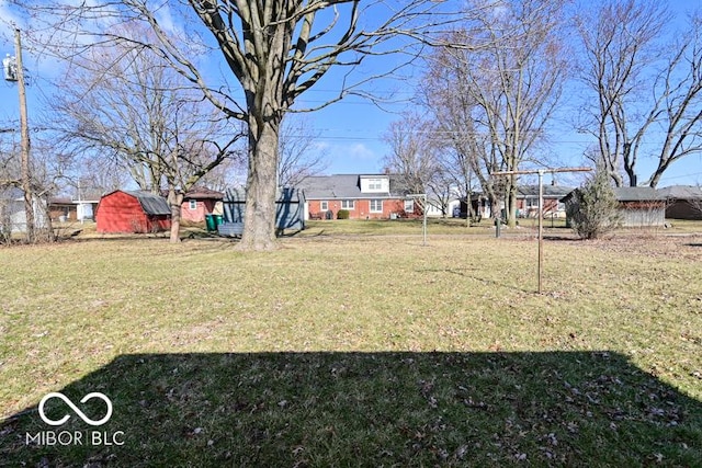 view of yard with an outdoor structure and a shed