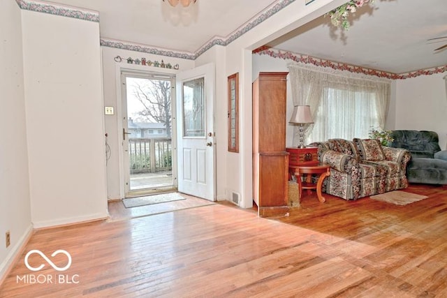 entrance foyer featuring baseboards and hardwood / wood-style flooring