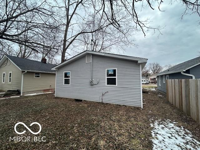 back of house with fence