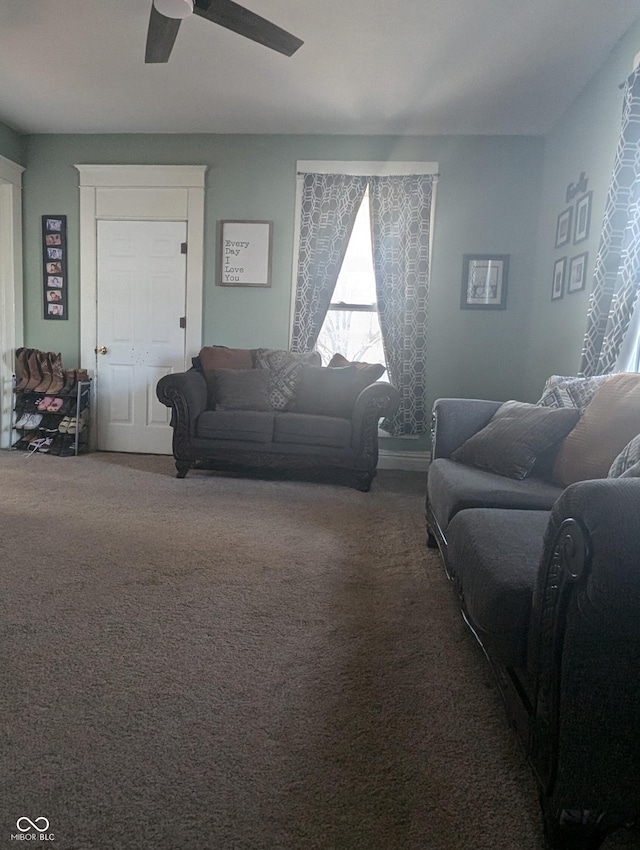 carpeted living room with a ceiling fan