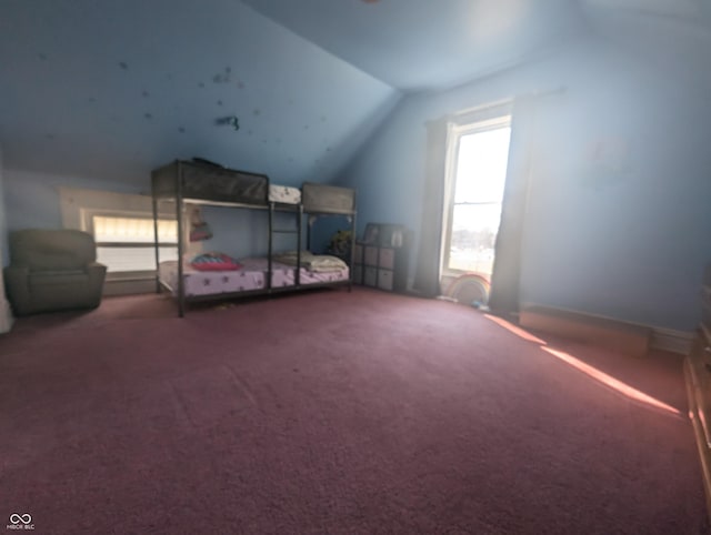 unfurnished bedroom with carpet flooring and vaulted ceiling