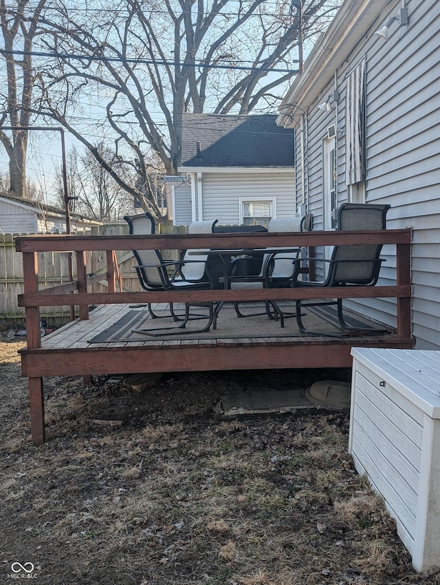 wooden terrace featuring fence