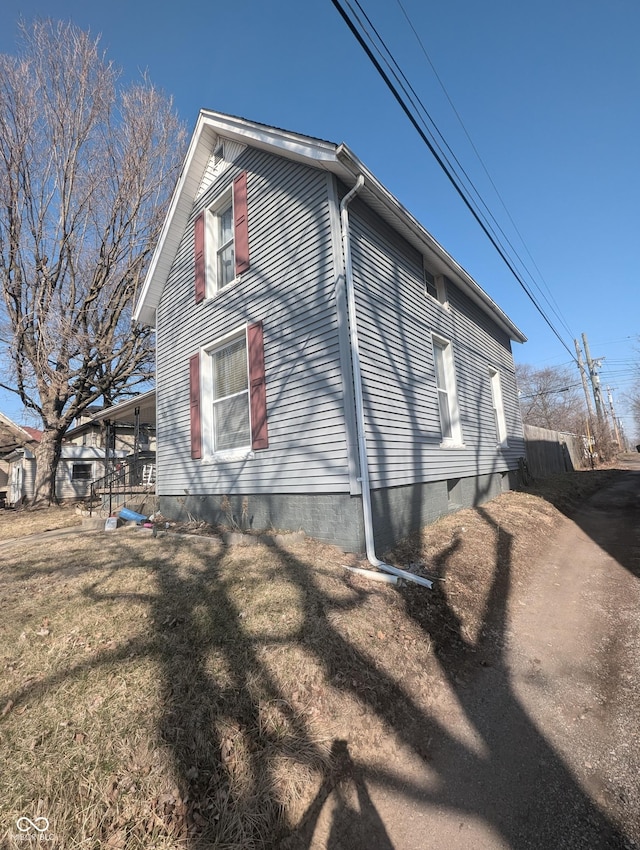 view of side of home featuring a lawn