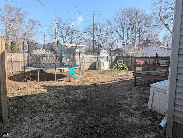 view of yard with a fenced backyard and a trampoline