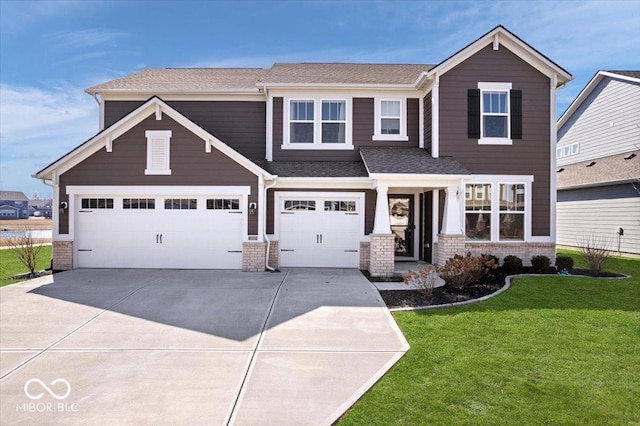 view of front of house featuring brick siding, driveway, an attached garage, and a front yard