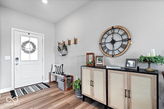 entrance foyer featuring baseboards and wood finished floors