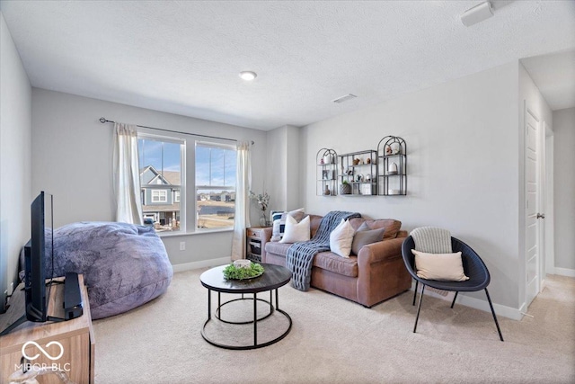 carpeted living area with visible vents, baseboards, and a textured ceiling