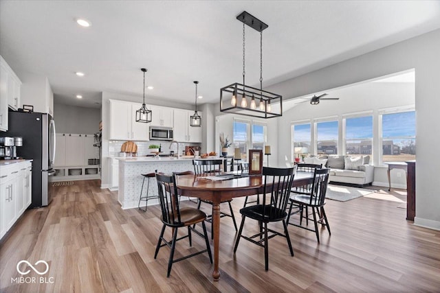 dining room with recessed lighting, a healthy amount of sunlight, and light wood finished floors