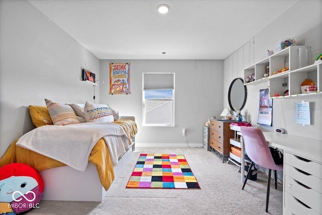 bedroom with light colored carpet and baseboards