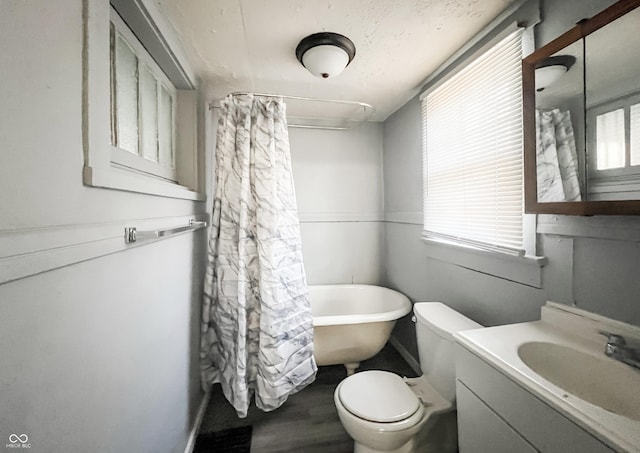 bathroom featuring toilet, a washtub, wood finished floors, a shower with shower curtain, and vanity