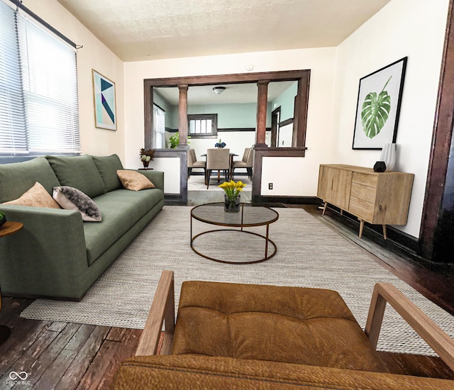 living area featuring dark wood-type flooring and baseboards