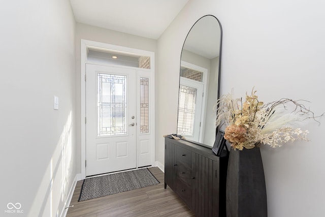 foyer entrance featuring light wood-type flooring and baseboards