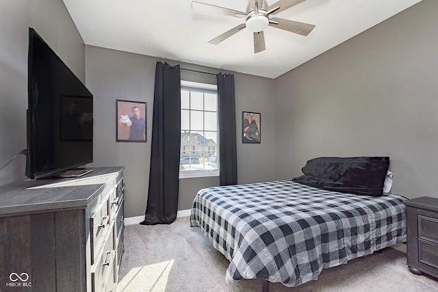 bedroom with baseboards, light colored carpet, and a ceiling fan