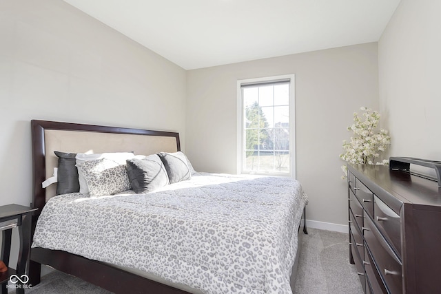 bedroom with light carpet and baseboards