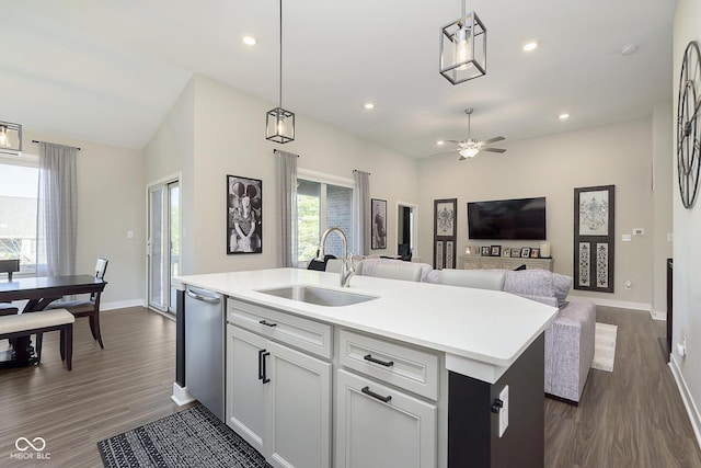 kitchen featuring light countertops, recessed lighting, open floor plan, and a sink