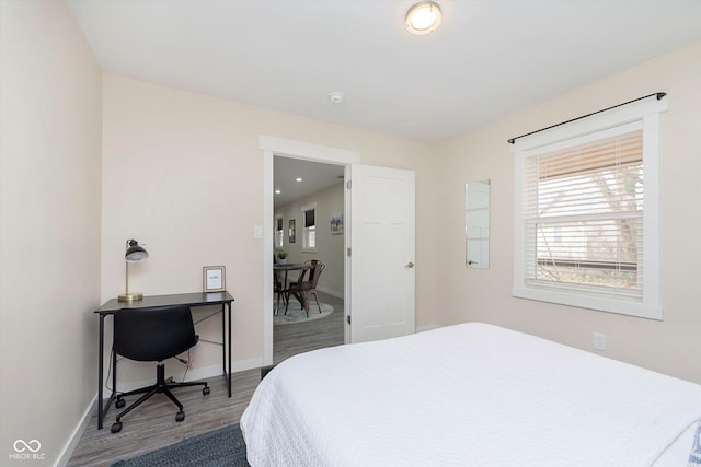 bedroom with baseboards and wood finished floors