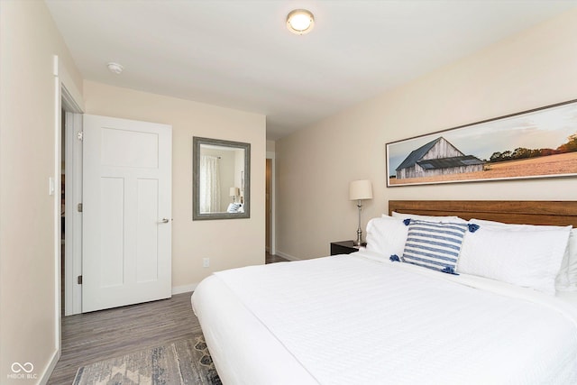 bedroom with baseboards and wood finished floors