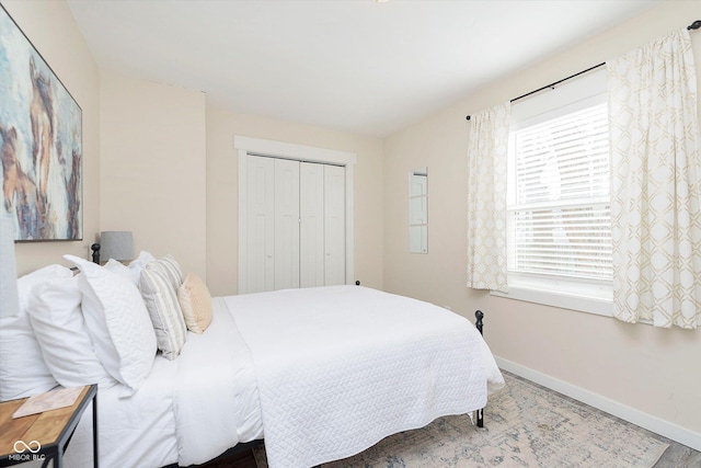 bedroom featuring a closet and baseboards