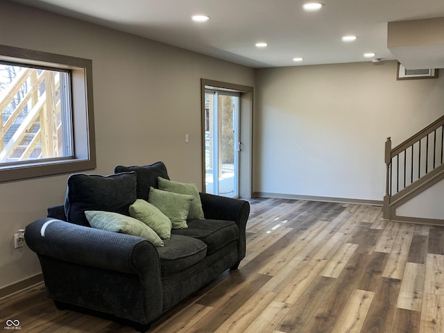 interior space featuring visible vents, hardwood / wood-style flooring, recessed lighting, baseboards, and stairs