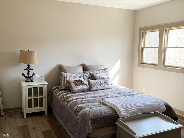 bedroom with baseboards and wood finished floors