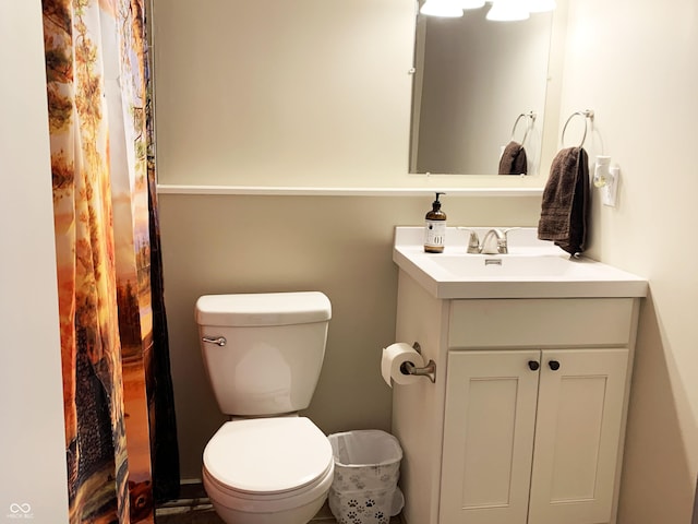 bathroom with vanity, curtained shower, and toilet