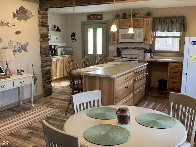 kitchen with a center island, decorative light fixtures, light countertops, dark wood-style floors, and white appliances