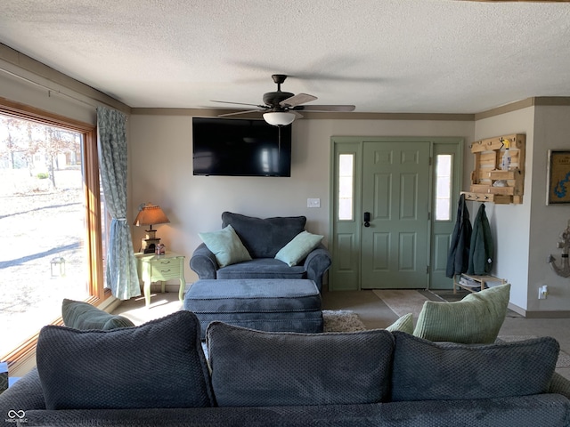 living area with a textured ceiling and a ceiling fan