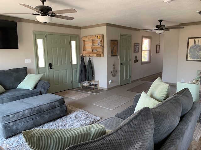 living area with a textured ceiling, a healthy amount of sunlight, and ceiling fan