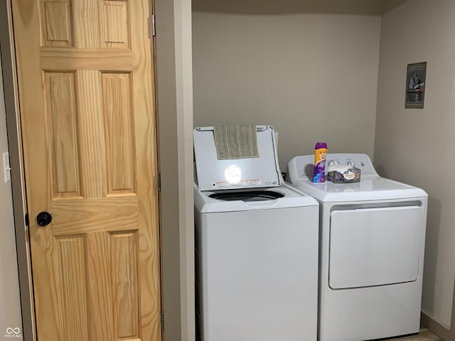 clothes washing area featuring separate washer and dryer