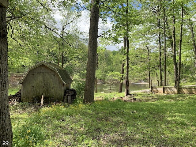 1925 Lee Kay Dr, Rockville, IN 47872 - view of yard with an outbuilding, a wooded view, and a storage unit