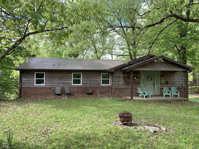 1925 Lee Kay Dr, Rockville, IN 47872 - single story home featuring metal roof, an outdoor fire pit, brick siding, and a front yard