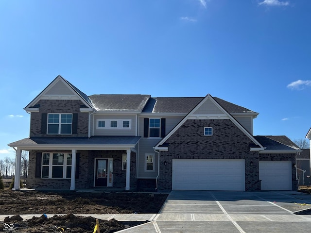 view of front of house featuring concrete driveway, an attached garage, brick siding, and covered porch