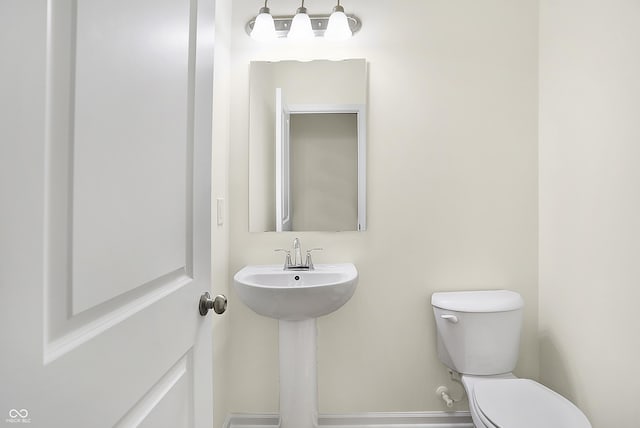 bathroom featuring toilet and a sink